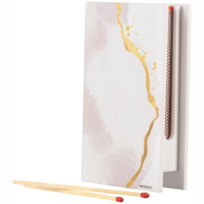 Watercolor matchbox holder with soft pink and gold watercolor design, displayed with matches and a paintbrush, perfect for Shabbat candle lighting.