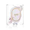 Watercolor Tzedakah Box with hand-painted oval design in soft beige and purple tones, displayed in clear packaging with decorative bow.