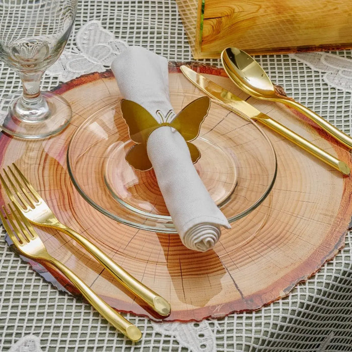 Natural wood charger plates with gold utensils and napkin on place setting, elegant table decor for holiday dining.