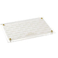 Woven Hadlokas Neiros tray with white woven base and brass corner accents for Shabbat candle lighting.