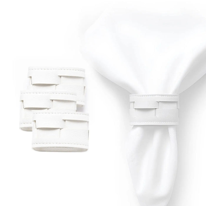 Woven leather napkin wraps in silver and gold displayed flat, showing the woven texture and metallic finishes for elegant table setting.